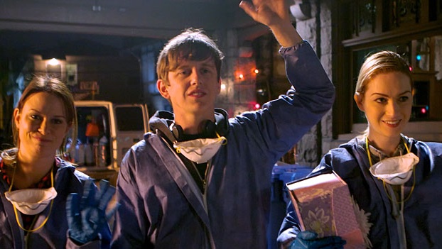 A scene from Episode 3 of Dirty Work. Roxy (Mary Lynn Rajskub), Pete (Hank Harris), and Michelle (Jamie Clayton) in blue work uniforms.