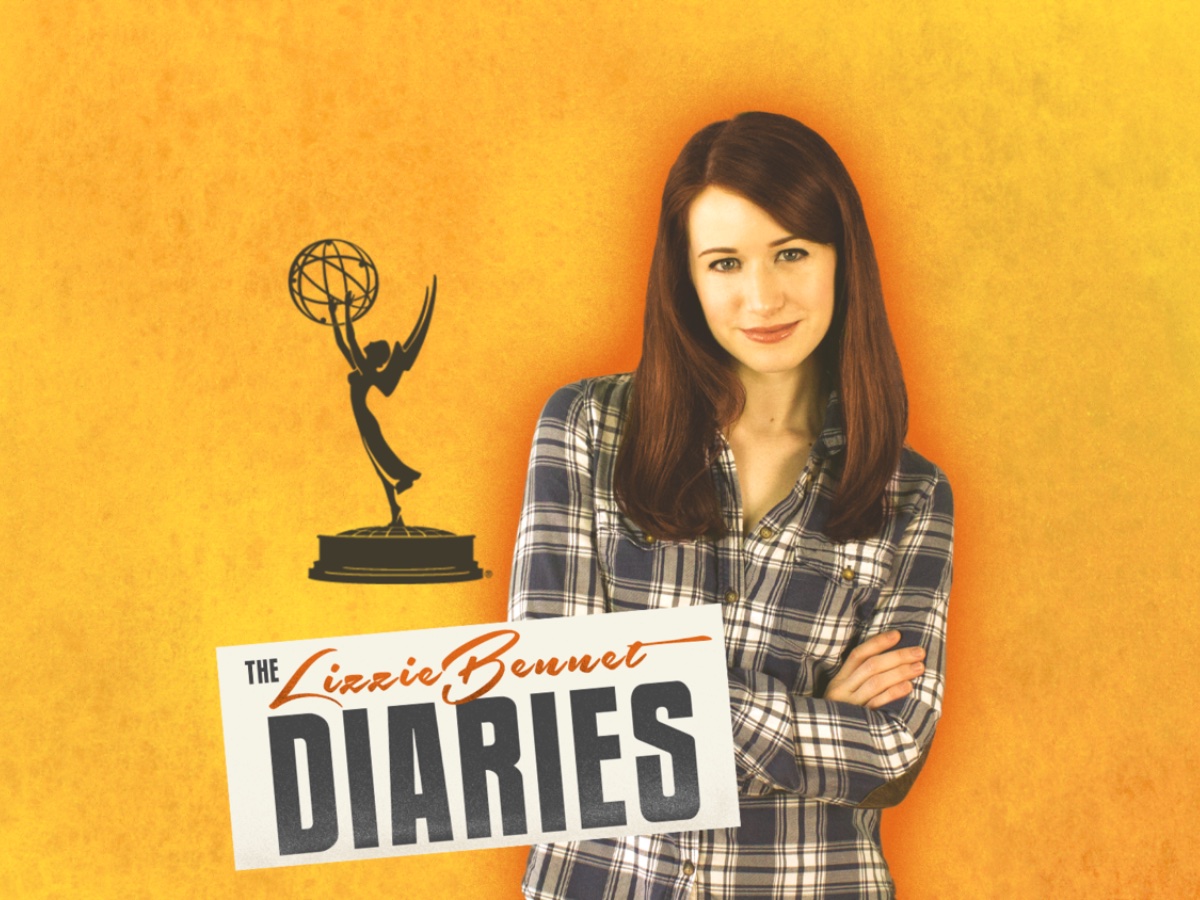 Promotional image for The Lizzie Bennet Diaries, featuring Ashley Clements as Lizzie, with the series title in bold white text over a warm, softly lit background, and an image of an Emmy statuette.